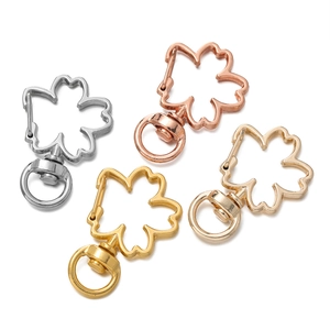 Detailed view of cherry blossom lobster clasps in silver, gold, and rose gold finishes