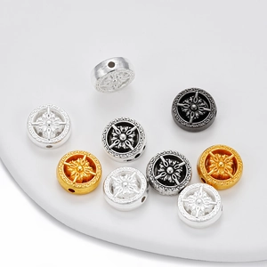 Vue macro de perles vajra en alliage avec motif soleil en argent, or et noir