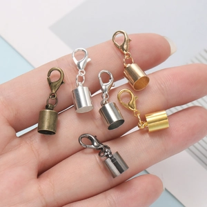 DIY jewelry lobster clasp and end cap connectors in multiple metallic finishes held in hand