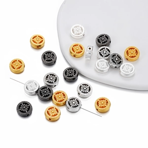 Détails macro des perles boussole vajra en alliage doré argenté et noir pour bijoux