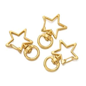 Detailed view of three gold-plated star-shaped alloy lobster clasps on a white background