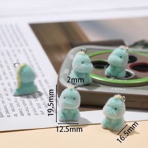 Macro view of mint green flocked dinosaur charm with dimensions 19.5mm by 12.5mm