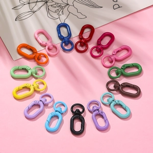Colorful alloy lobster clasp keychains in 14 vibrant shades on pink background