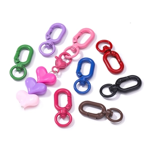 Macro detail of multi-colored lobster clasps and heart charms for DIY crafts