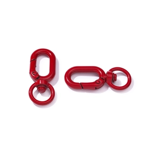 Detail of red metal swivel lobster clasps with smooth colorful lacquer finish for DIY