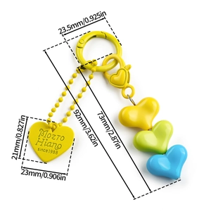 Detailed view of colorful heart-shaped resin charms and a branded yellow heart tag