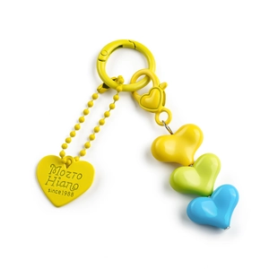 Macro detail of colorful resin heart beads and engraved metal tag on the keychain