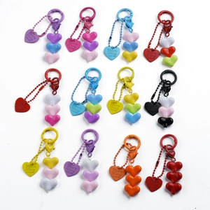Collection of colorful resin heart beaded keychains in twelve vibrant color combinations