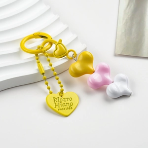 Detailed close-up of resin heart charms in yellow and pink on a stylish keychain