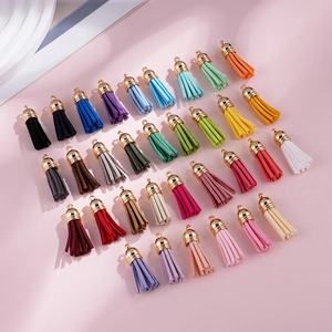 Macro detail of 3.8cm colorful CCB plastic suede tassels with golden caps for DIY jewelry