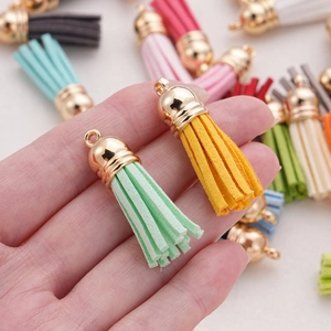 Macro detail of 38mm mini suede tassels with gold metal caps for DIY jewelry making