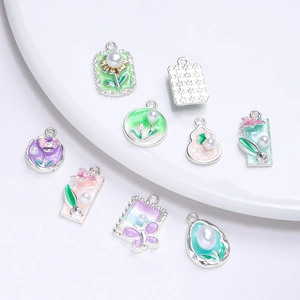 Close-up of pastel enamel butterfly and starfish charms with pearls for DIY jewelry