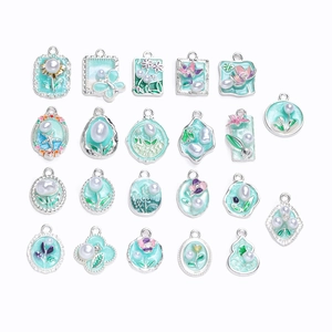 Detail of silver alloy DIY pendants with mint green enamel and faux pearls