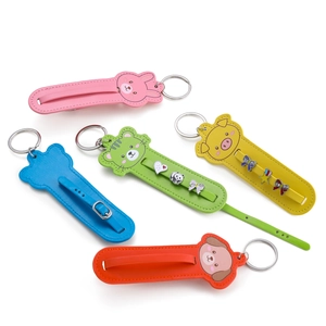 Detailed flat lay of colorful cartoon animal leather keychains with polished metal rings