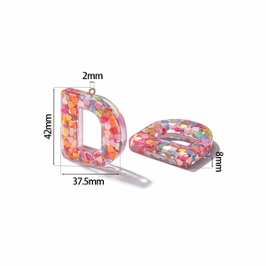 Detailed size view of a pink resin letter D pendant with heart shaped colorful sequins