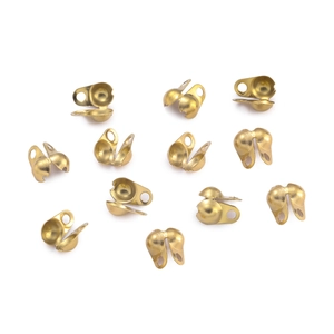 Close-up of golden stainless steel bead tips and calottes for DIY jewelry making