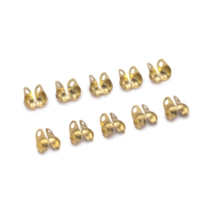 Close-up of golden double-hole clamshell bead tips for DIY jewelry making and finishing