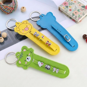 Detailed view of colorful leather cartoon animal keychains with decorative metal charms