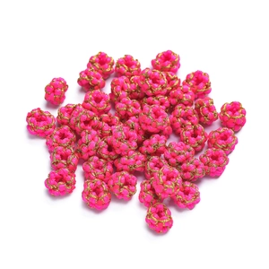 Detailed macro view of pink and gold handmade braided wire rings for DIY jewelry
