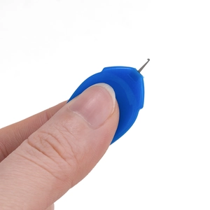 Macro view of a blue needle threader tool showing the small metal hook and plastic handle