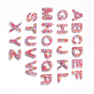 Set of 26 pink resin alphabet pendants with colorful heart sequins for DIY keychains