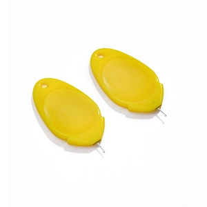 Macro view of two yellow acrylic needle threaders with fine steel wire hooks