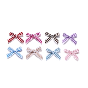 Close-up of 8 colorful checkered bow accessories with scalloped edges for DIY crafts