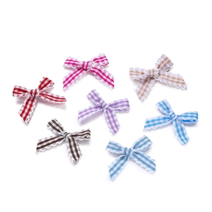 Detail of colorful plaid bows with scalloped edges for DIY accessories and gift decor