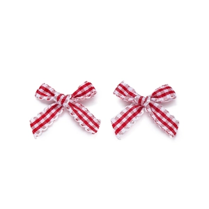 Close-up of red and white plaid bows with scalloped edges for DIY hair accessories