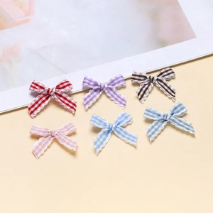Set of six colorful striped bowknot accessories with white lace edges for DIY crafts