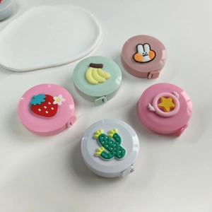Macro view of five colorful 3D cartoon mini retractable tape measures in various designs