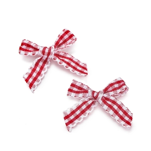 Detail of red and white checkered bows with delicate lace edges for hair accessories