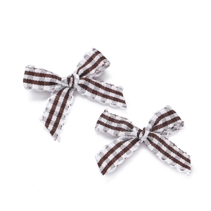 Detailed view of striped fabric bows with scalloped edges for DIY hair accessories