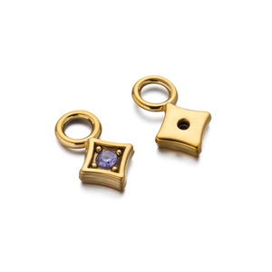 Detail view of gold-plated star pendant with purple gemstone for DIY jewelry making