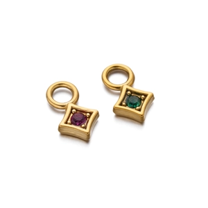 Macro view of gold plated square pendant with purple and green gemstone inlay