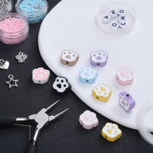 Macro detail of colorful cat paw alloy beads with vertical holes for DIY jewelry crafting