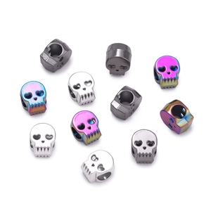 Close-up of rainbow and silver skull beads with heart-shaped eyes for DIY bracelets