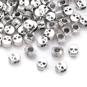 Close-up of polished silver skull beads with precision holes for DIY jewelry making