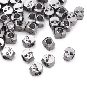Close-up of gunmetal alloy skull beads with side holes for DIY jewelry making