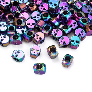 Macro detail of iridescent rainbow skull beads with side holes for DIY jewelry