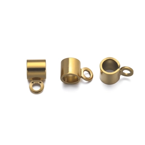 Macro view of gold plated cylinder end caps with loops for DIY jewelry making