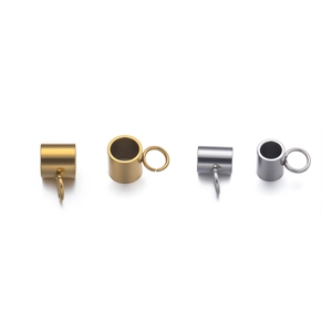 Detailed view of matte gold and silver cylindrical jewelry connectors with small rings