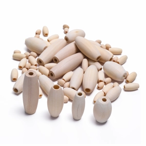 Macro view of assorted oval and spindle-shaped natural wood beads for DIY jewelry making