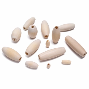 Macro shot of oval natural wood beads in various sizes with smooth finish and central holes