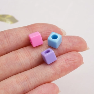 Macro shot of 7mm colorful acrylic cube beads with heart pattern for DIY jewelry making