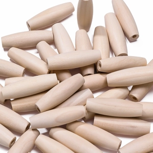 Macro detail of oval spindle-shaped natural wood beads with smooth grain and pre-drilled holes