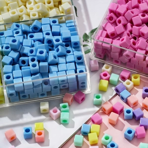 Macro detail of 7mm colorful acrylic cube heart beads for DIY jewelry making