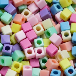 Macro shot of 7mm colorful acrylic cube beads with holes for DIY jewelry and crafts