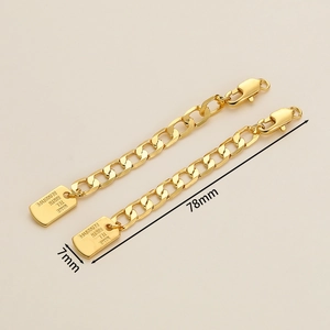 Detailed view of 18K gold-plated extension chains with ID tags and lobster clasps
