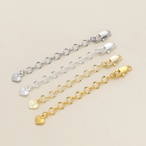 Detail of 18K gold and silver plated clover leaf extender chains with heart pendants
